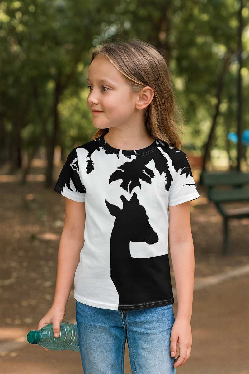 Smiling child wearing a Kids T-Shirt with Deer design featuring a black silhouette of a deer under a tree on a white background, minimalist artistic style inspired by nature and wildlife.