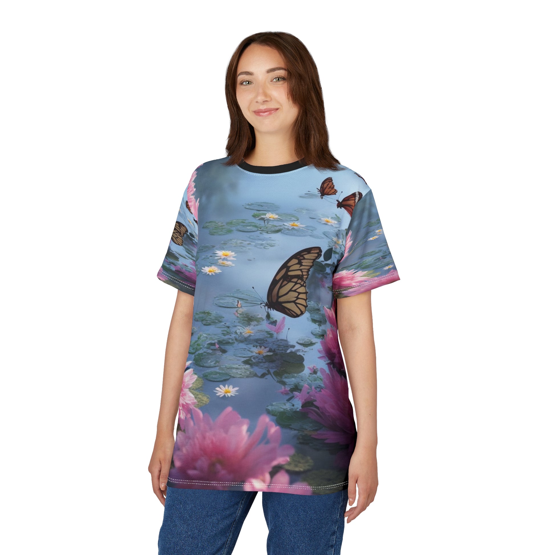 Unisex t-shirt featuring a peaceful water scene with butterflies, lily pads, pink waterlilies, and daisies on a soft blue background – nature-inspired design by allmyart.net
