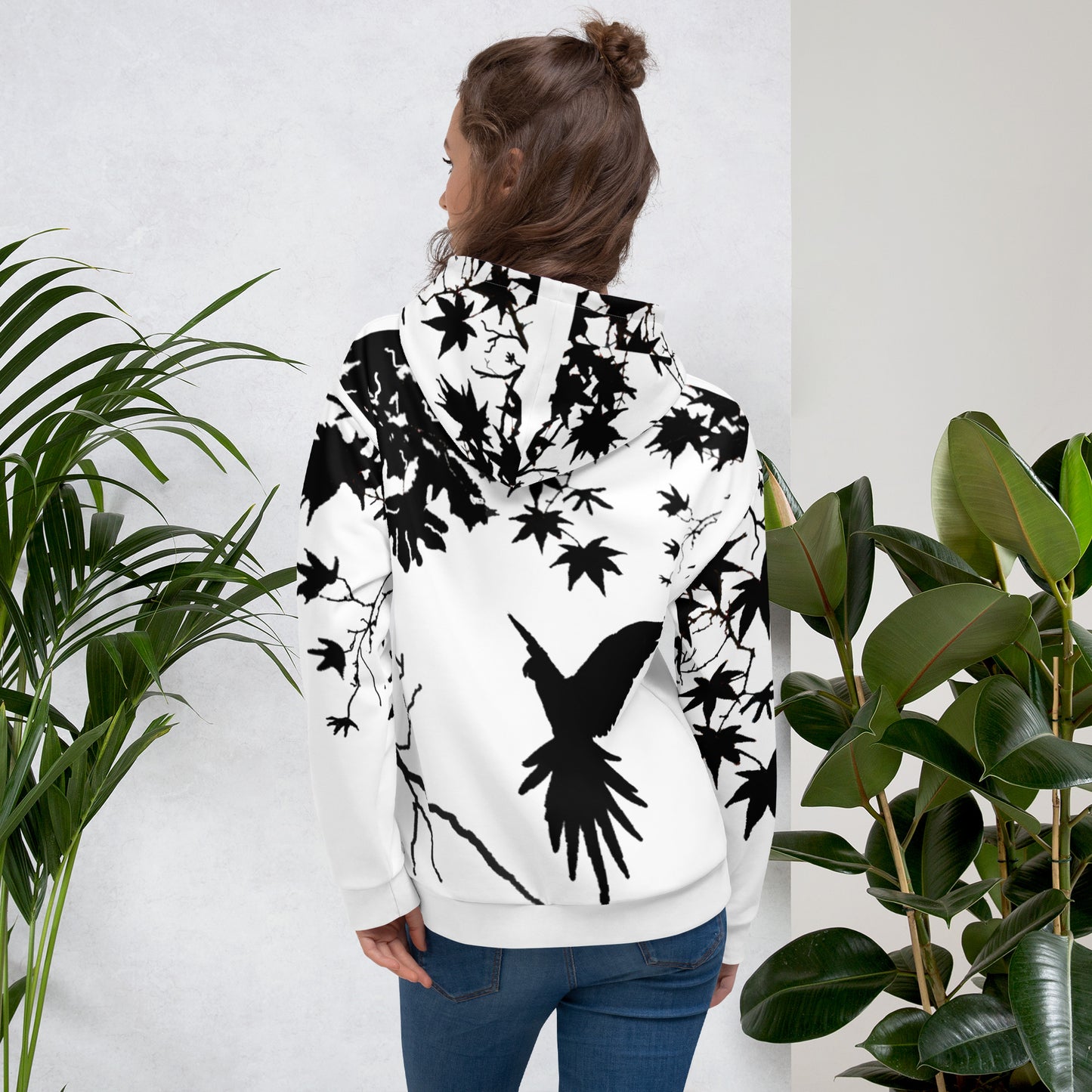 Unisex Hoodie with Freedom black-and-white design showing a bird flying toward branches. Artistic and minimalist silhouette style, made from soft recycled fabric with brushed fleece interior for comfort and modern eco-friendly fashion.