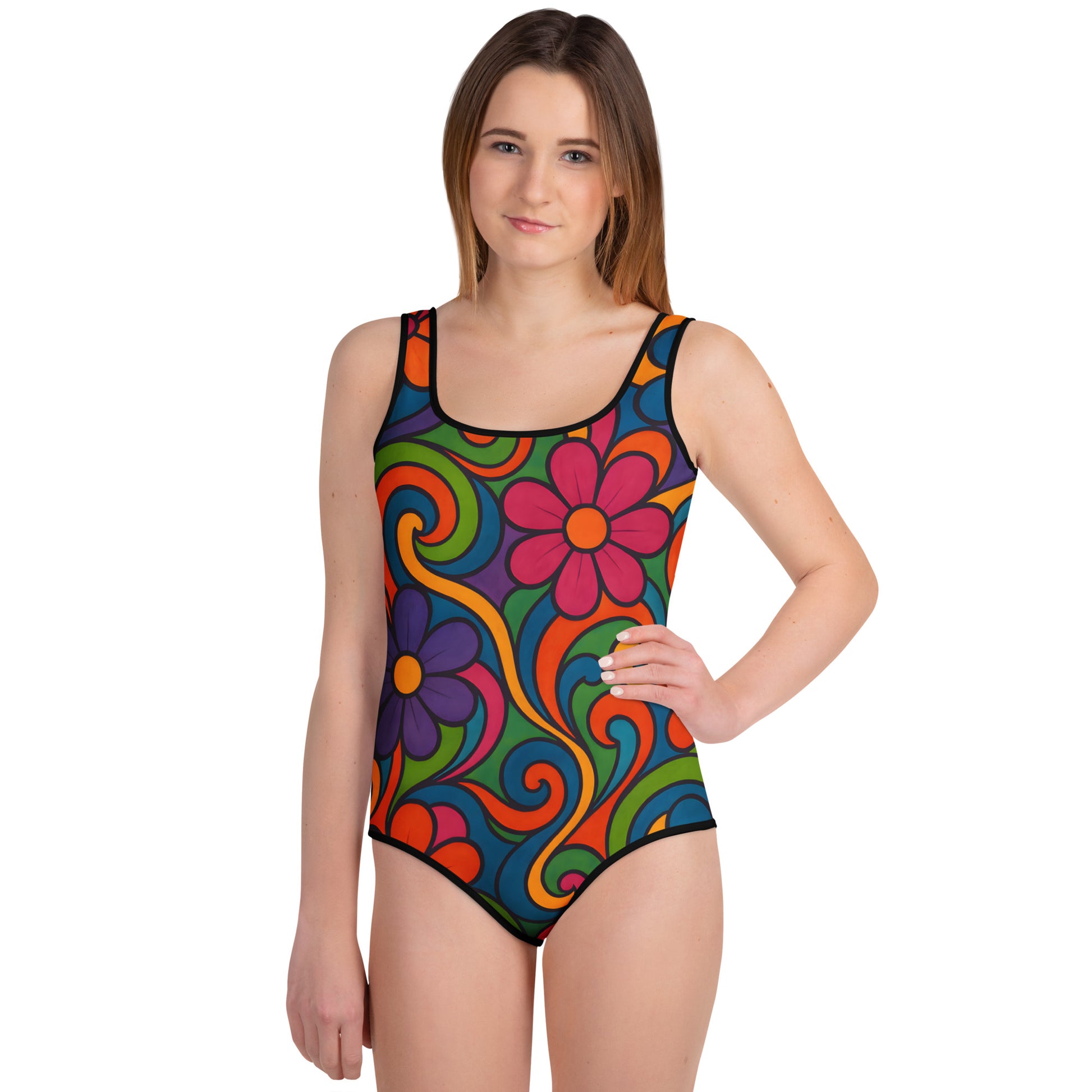 Youth Swimsuit – Flower Joy Naïve 60s Bloom design featuring vibrant retro floral swirls in red, orange, purple, and blue on soft eco-fabric. Inspired by 1960s art naïf, perfect for beach or pool wear.