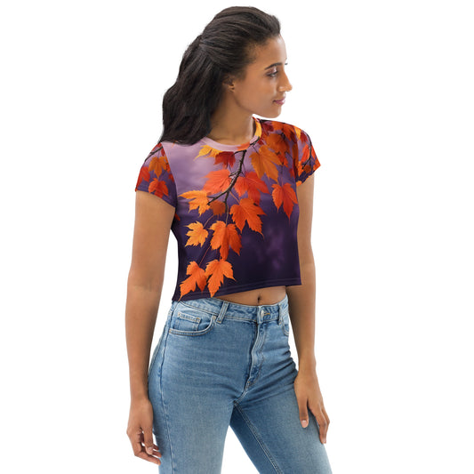 All-over print crop tee featuring the Autumn Glow Crimson Leaves design — a vintage botanical artwork with vivid red and orange leaves on a deep violet background, evoking warmth, contrast, and late-autumn elegance.