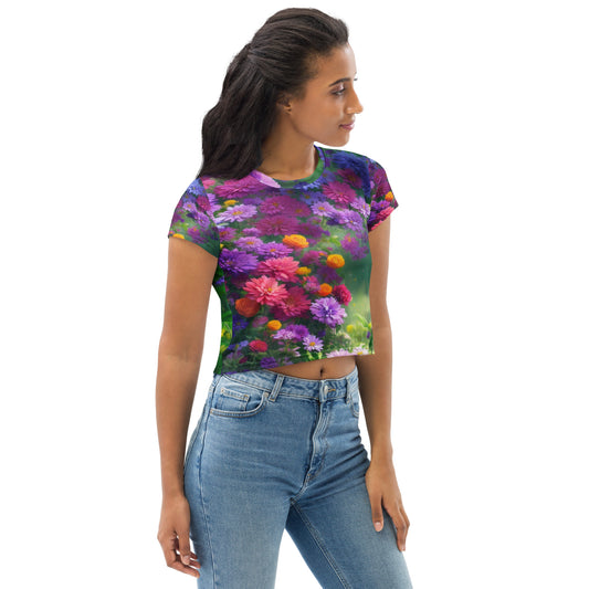 All-over print crop tee featuring the Fleuri design — a naive and impressionist floral artwork blending pink, violet, yellow, and green tones into a luminous spring garden full of artistic emotion and color harmony.
