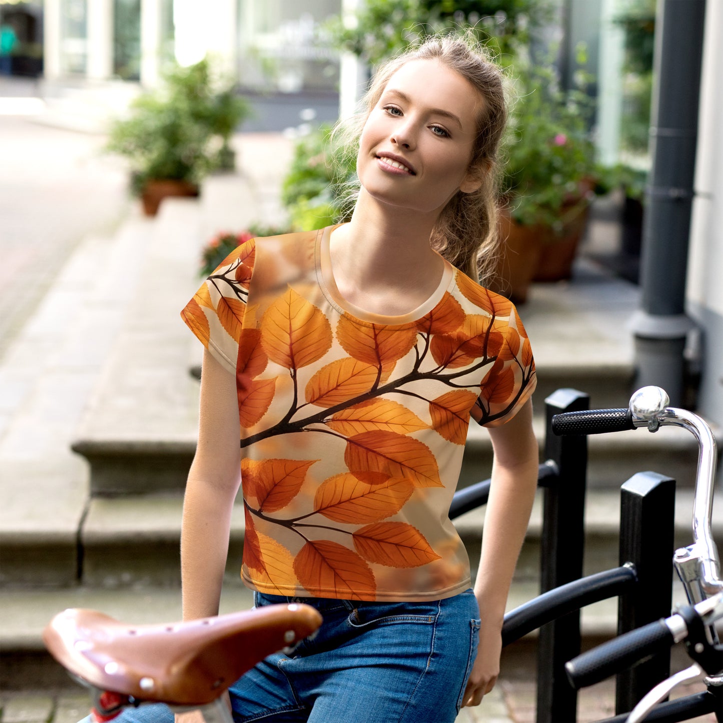 All-over print crop tee featuring the Golden Serenity Autumn Leaves design, a vintage botanical composition with golden amber leaves on soft beige tones, evoking warmth, serenity, and timeless autumn beauty.