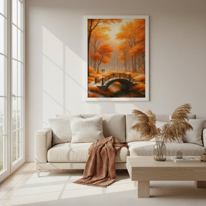Framed poster Golden Autumn Bridge hanging above a beige sofa in a bright modern living room with large windows, soft natural daylight and light wood furniture, showing an autumn forest landscape with glowing orange trees, a curved bridge over water and two distant walkers