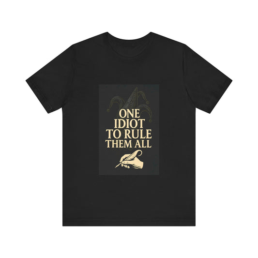 Unisex T-shirt with the humorous quote “One Idiot to Rule Them All,” a witty parody for geeks and writers. French artistic design printed by Canadian or American companies with worldwide branches.