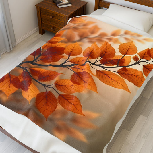 Velveteen Plush Blanket on bed featuring glowing autumn leaves in warm golden orange tones, soft cozy fabric, nature-inspired fall design, elegant seasonal home decor throw for bedroom or living space, inviting warm atmosphere for comfort and relaxation.