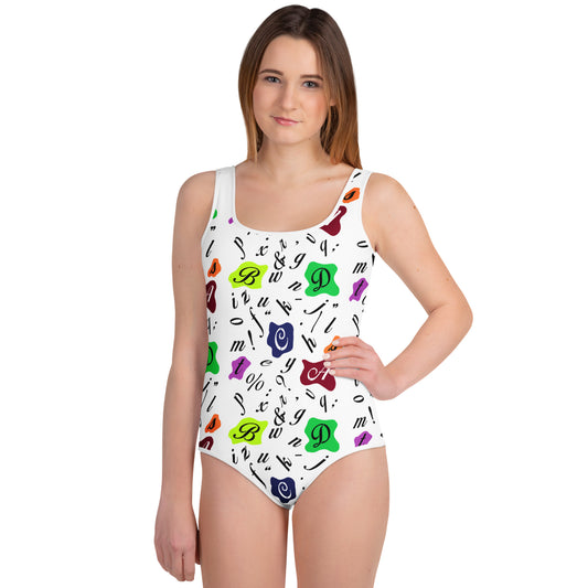 Youth swimsuit featuring a colorful artistic pattern of letters and typographic symbols on a white background. Handmade on demand for comfort and durability, this artistic swimwear brings a playful retro style perfect for young creative swimmers.