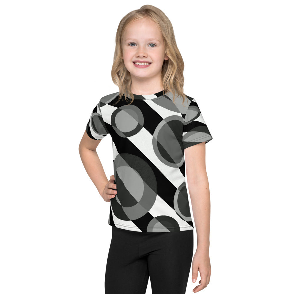 Smiling child wearing a Kids T-Shirt with Bubble 2 abstract retro design featuring overlapping gray and black geometric circles inspired by 60s and 70s art, minimalist and stylish.