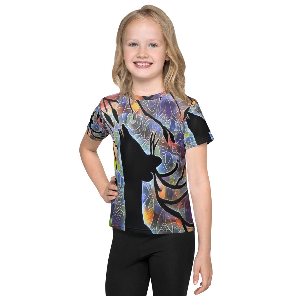 Smiling child wearing a Kids T-Shirt with Deer (2) fantasy nature design showing a deer silhouette eating from a tree branch, with a colorful glowing sky in the background, inspired by magical nature.