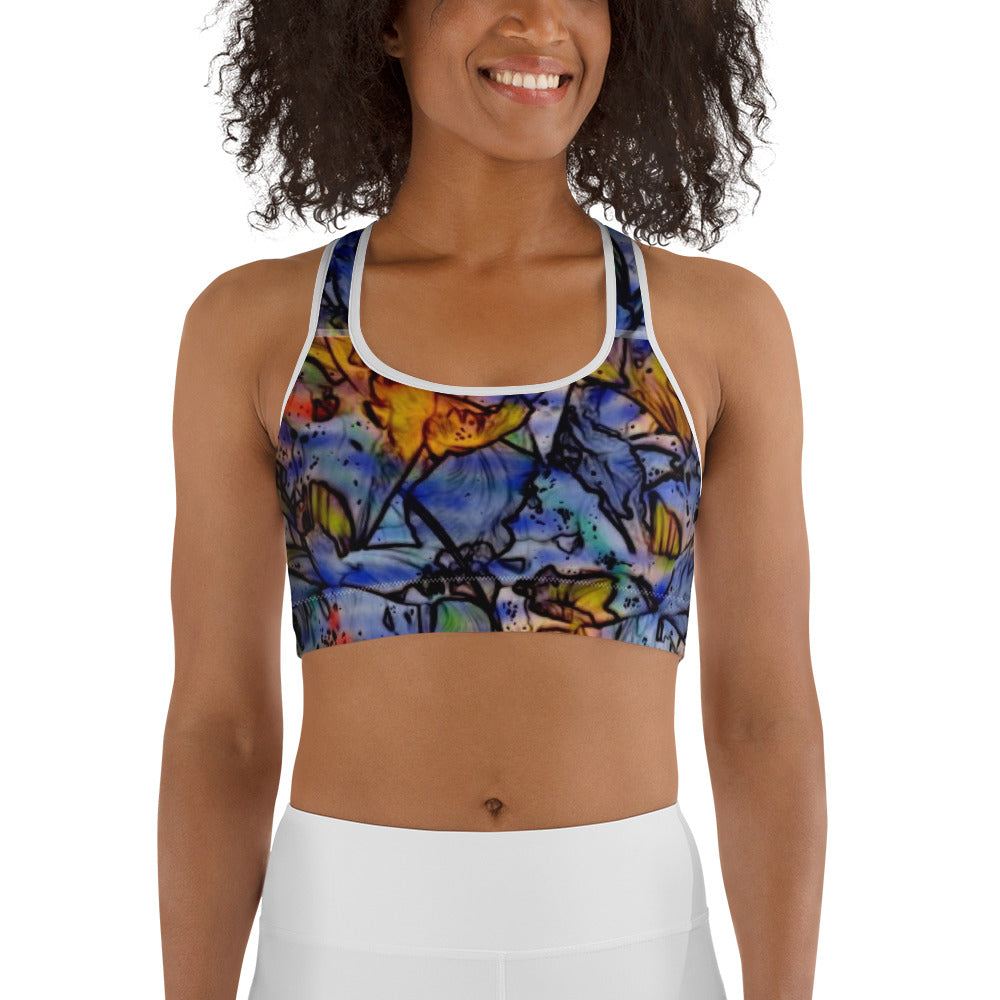 Woman wearing a floral impressionist sports bra with blue, orange, and yellow artistic flower design. Unique activewear design by allmyart.net for gym, yoga, or casual outfits.