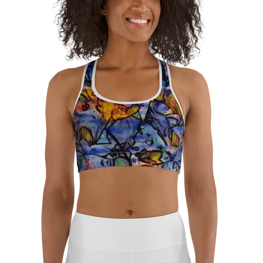 Woman wearing a floral impressionist sports bra with blue, orange, and yellow artistic flower design. Unique activewear design by allmyart.net for gym, yoga, or casual outfits.