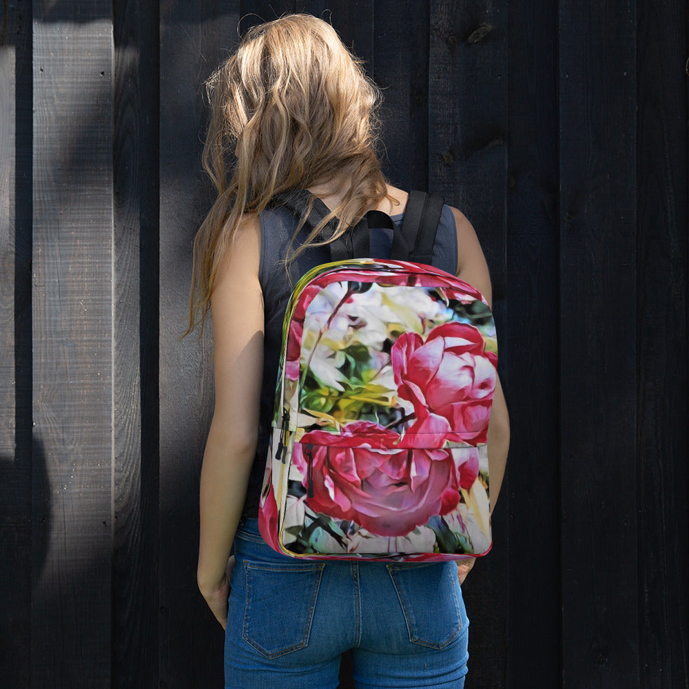 a woman holding a pink suitcase in front of a building 