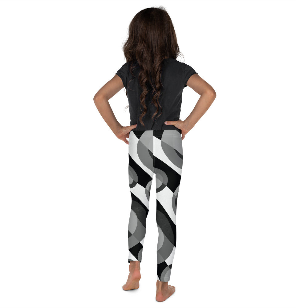 a young boy holding a skateboard in the air 