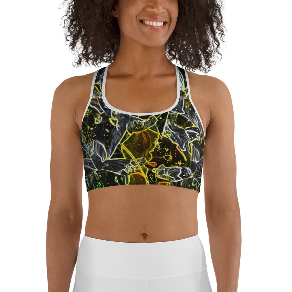Woman smiling and wearing a dark floral sports bra with glowing neon outlines in yellow, green, and white. Modern active-wear design with bold contrast, ideal for fitness and everyday comfort.