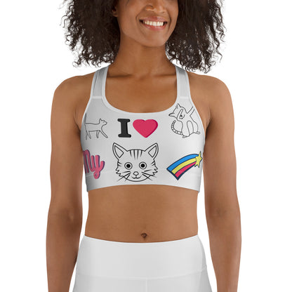 Woman wearing a fun white sports bra with colorful cartoon cat illustrations, rainbow star, and “I love my cat” text design.