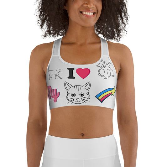 Woman wearing a fun white sports bra with colorful cartoon cat illustrations, rainbow star, and “I love my cat” text design.