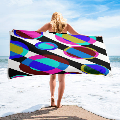 a woman holding a colorful kite on a beach 